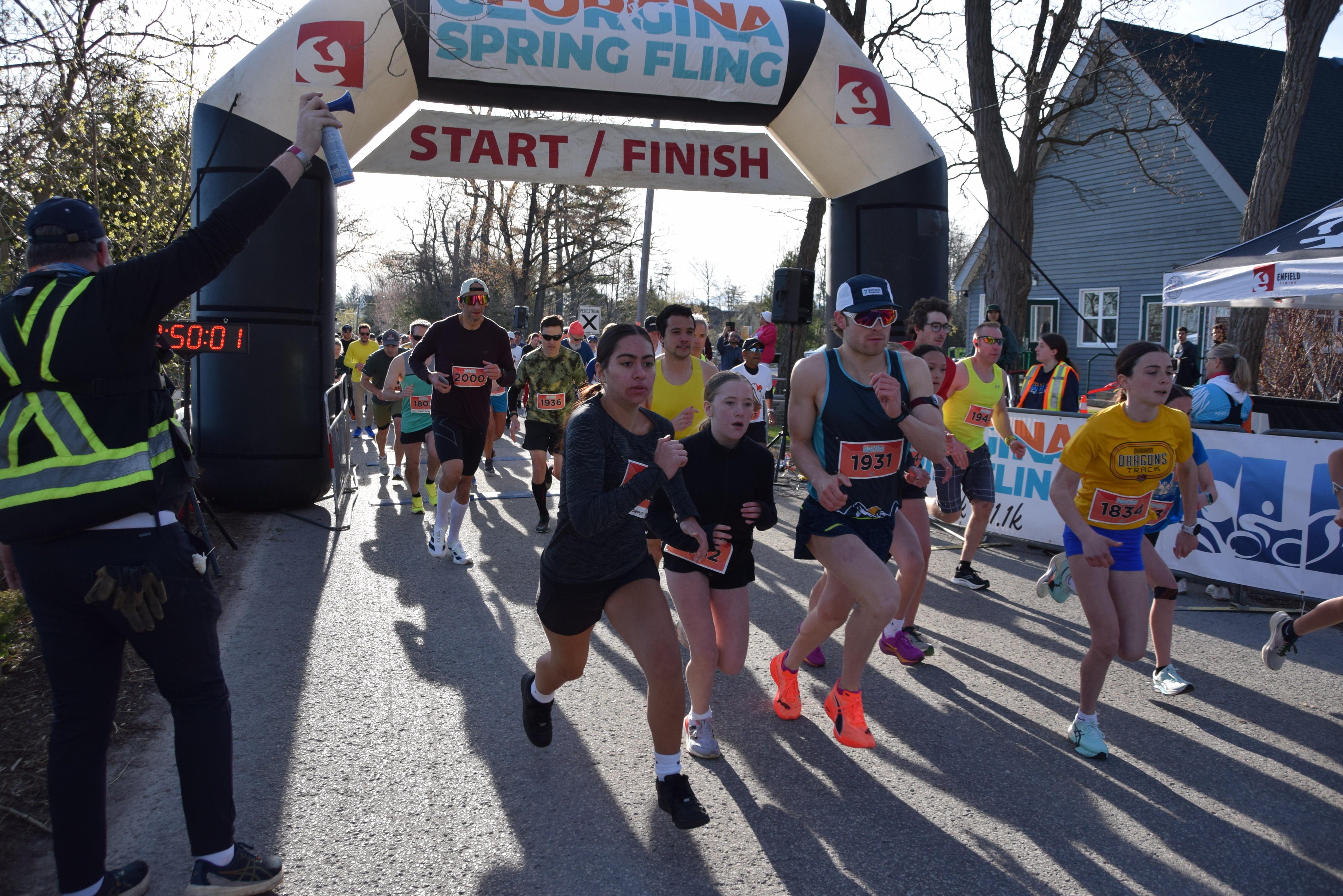 Runners start at the Georgina Spring Fling 5k distance with a sunny backdrop